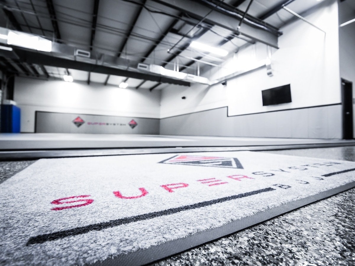 A branded floor pad in a jiu-jitsu gym construction project.